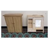 1064	2 MEDICINE CABINETS. ONE HAS A MIRROR DOOR, LARGEST IS 25 IN W 28 IN H 7 IN DEEP. ONE W/ MIRROR