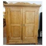 1065	LARGE PINE WARDROBE HAS DRAWERS BENEATH PANELED DOORS, 81 IN H, 65 IN W, 24 IN DEEP. 