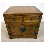1072	SMALL PAINT DECORATED ASIAN STAND HAS 2 DOORS & 2 DRAWERS. 20 IN W, 16 IN DEEP, 19 1/2 IN DEEP 