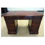 1073	MAHOGANY KNEEHOLE DESK W/ RED LEATHER TOP, HAS 8 DRAWERS ONE IS DEEP. 45 IN W, 23 IN DEEP, 32 I
