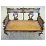 1080	CARVED & CANED RUSH BOTTOM LOVE SEAT, HAS A CUSHION. 47 IN W 