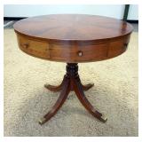 1082	4 DRAWER DRUM TABLE W/ BRASS FEET. 32 IN DIAMETER, 29 IN H 