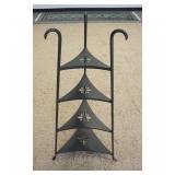 1085	TRIANGULAR IRON FOUR TIER SHELF, 41 IN H, THE SHELVES HAVE FLOWER CUT OUTS.