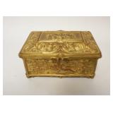 1143	BRASS FRENCH SILK LINED BOX HIGHLY EMBOSSED W/ CHERUBS, 4 IN X 3 IN X 1 3/4 IN H 