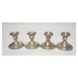 1197	TWO PAIRS OF WEIGHTED STERLING SILVER CANDLESTICKS, ONE IS TWISTED UNDER THE CUP