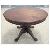 1003	OVAL WALNUT VICTORIAN CLAW FOOT LAMP TABLE W/ LEAF & VINE CARVED SKIRT 36 IN X 30 1/2 IN X 27 1
