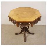 1090	INLAID OCTAGONAL TABLE W/OPEN CARVED SKIRT, HAS OPEN CARVED PEDESTAL, TOP IS 29 IN ACROSS, 29 1