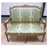 1159	CARVED UPHOLSTERED PAINT DECORATED ITALIAN SETTEE. 46 IN X 42 IN HIGH. HAS SOME STAINING ON UPH