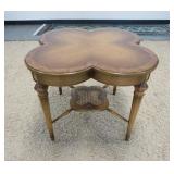1176	CLOVER TOP BURL BANDED LAMP TABLE WITH A CANNED LOWER CENTER SHELF. 26 IN X 23 IN HIGH