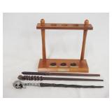 1182	LOT OF THREE HARRY POTTER WANDS & A WAND DISPLAY. DISPLAY IS 8 IN X 9 IN 3 1/4 IN DEEP. 