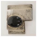 1043	STERLING SILVER BROOCH W/BLACK CABOCHON, STONE IS CHIPPED, 2 5/8 IN X 2 1/4 IN, 1.325 TOTAL TOZ