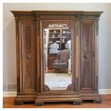1108	3 DOOR CARVED CONTINENTAL WARDROBE, MIRRORED CENTER DOOR, SIDE DOORS HAVE BURL PANELS, 87 IN HI