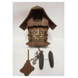 1245	CUCKOO CLOCK, SOMETHING MISSING ON HEADS OF THE 2 FIGURES, BODY OF CLOCK IS 16 1/4 IN HIGH