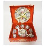 1248	MINIATURE ASIAN TEA SET IN A FABRIC COVERED BOX, BOX IS 7 5/8 IN X 6 1/8 IN X 3 IN HIGH