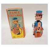1313	MEGO MECHANICAL PEACE CORPS MAN, TIN WIND UP IN ORIGINAL BOX