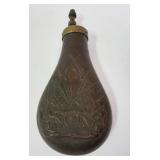 1024	ANTIQUE POWDER FLASK, COPPER W/EMBOSSED CANON & GUNS