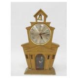 1206	MASTERCRAFTERS BUILDING FORM CLOCK, HAS A BELL ON TOP & A FIGURE INSIDE W/A PICTURE OF LAUREL &