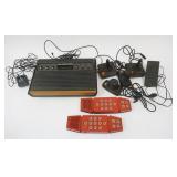 1249	ATARI VIDEO COMPUTER SYSTEM, INCLUDES 2 PARKER BROTHERS MERLIN GAMES & CONTROLLERS