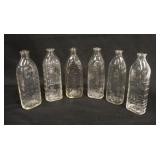 1268	6 VINTAGE BABY BOTTLES  W/MOLDED IMAGES OF BABIES, 6 3/4 IN HIGH