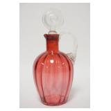 1057	BLOWN CRANBERRY JUG W/OPTIC RIB PATTERN, APPLIED TWIST HANDLE, WAFER STOPPER, POLISHED PONTIL, 