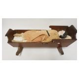 1149	DOLL CRADLE W/DAMAGED DOLL, CRADLE REPAIRED
