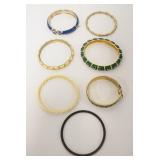 1166	7 BANGLE BRACELETS, ONE MARKED, ROPE TWIST ONE CRACKED AND BLACK TENNIS BRACELET WITH RED STONE