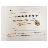 1201	JEWELRY LOT INCLUDING 6 NECKLACES ONE MISSING STONE, 2 BRACELETS ONE CLASP BROKEN AND AMBER PIN