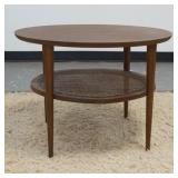 1357	LANE MID CENTURY MODERN ROUND LAMP TABLE, HAS A WOVEN SHELF BENEATH. HAS SOME MINOR DAMAGE