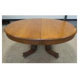 1043	OVAL OAK TABLE W/CARVED BASE, 60 IN X 48 IN X 29 1/2 IN HIGH