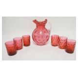 1107	CRANBERRY INVERTED THUMBPRINT 7 PIECE WATER SET, PITCHER HAS CLEAR APPLIED RIBBED HANDLE & IS 9