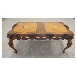 1123	FIGURAL CARVED INLAID COFFEE TABLE, PUTI ON THE CORNERS, ON HAS A PIECE OF THE ARM BROKEN OFF, 