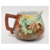 1140	HAND PAINTED PITCHER W/RED BERRIES, HAND INCISED #73 UNDER GLAZE, 6 3/4 IN HIGH