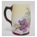 1141	HAND PAINTED WILLETS BELLEEK MUG W/PURPLE GRAPES