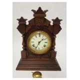 1151	ANSONIA VICTORIAN CLOCK, CARVED CASE, CHIP ON THE CARVING LOWER LEFT, 11 1/2 IN WIDE X 15 IN HI