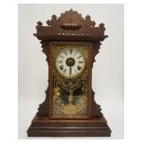 1195	CARVED WALNUT GINGERBREAD CLOCK W/PAINTED DOOR, 14 1/2 IN WIDE X 22 IN HIGH