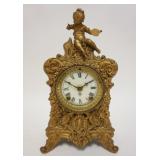1264	VICTORIAN METAL CLOCK W/FIGURAL TOP, WORKS ARE CORRODED, ANSONIA, 7 1/4 IN WIDE X 12 1/2 IN HIG
