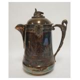 1003	REED & BARTON SILVER PLATED ICE WATER PITCHER, HAS A SWAN FINIAL, STORK HANDLE & FACES, PORCELA