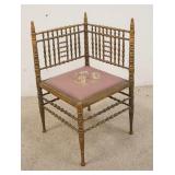 1132	SPOOL TURNED CORNER CHAIR HAS A GILT DECORATION, WORN ON THE POSTS, FLORAL SEAT, 17 IN WIDE X 3