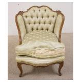 1134	CARVED UPHOLSTERED CHAIR W/WING BACK, TUFTED, FRONT OF UPHOLSTERY IS TORN, CHIP IN THE CARVING 