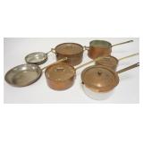 1206	LOT OF COPPER COOKWARE W/ BRASS HANDLES SEVEN PIECES ONE POT IS GLASS. LARGEST POTS ARE 8 IN DI