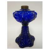 1304	COBALT BLUE KEROSENE LAMP, HAS GOOD WEAR & 2 MINOR CHIPS ON THE BASE, DRAPERY PATTERN, 9 1/4 IN