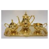 1095	WMF AMERICA 4 PIECE GOLD PLATED TEASETGODEN 49ER SERIES, TEAPOT HAS A REPAIRED FINIAL, 8 1/4 IN