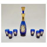1128	COBALT BLUE W/GOLD GLASS 7 PIECE CORDIAL SET, APPLIED PORCELAIN FLOWERS, DECANTER IS 11 1/2 IN 