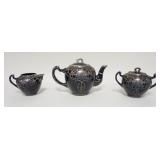 1140	3 PIECE SILVER OVERLAY PORCELAIN TEASET, LID OF THE TEAPOT HAS BEEN REPAIRED