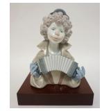 1144	LLADRO CLOWN HEAD W/ACCORDIAN, COMES W/WOODEN BASE, 7 1/4 IN HIGH