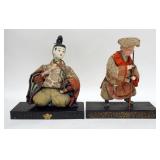 1291	PAIR OF ASIAN DOLLS ON DECORATED WOODEN BASES, 11 1/2 IN HIGH