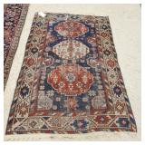 1027	ORIENTAL THROW RUG 3 FT 7 IN X 5 FT 6 IN HAS WEAR & A HOLE. 