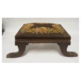 1086	CARVED UPHOLSTERED STOOL W/ BRASS CLAW FEET. 24 1/4 IN X 11 1 /4 IN AT THE SPLAYED FEET
