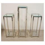 1289	3 MODERN CHROME & GLASS PEDESTALS, ALL ARE 12 IN SQUARE, TALLEST IS 48 IN HIGH, OTHERS ARE 36 I