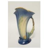 1013	ROSEVILLE BLUE PINECONE CORNUCOPIA VASE 10 1/2 IN H. HAS FLAT FLAKE ON THE UNDERSIDE OF THE BAS